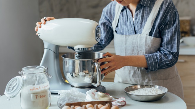 person using stand mixer